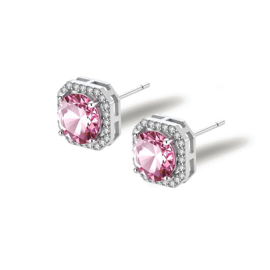 Pink moissanite studs in octagonal sterling silver halo settings with sparkling accent stones on cream background.