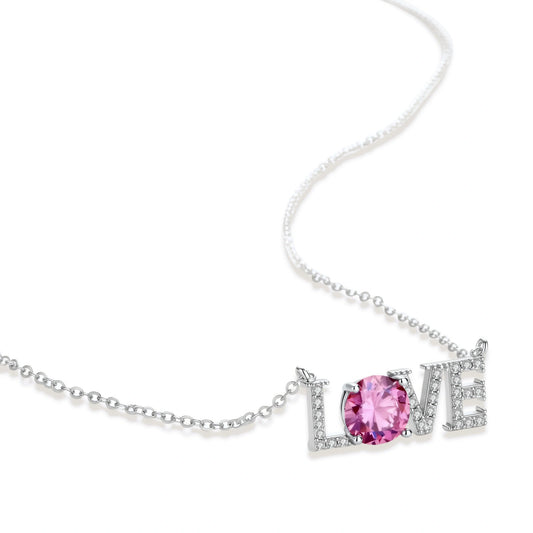 Sterling silver LOVE necklace with pink moissanite stone replacing the O, featuring crystal-set letters on delicate chain.