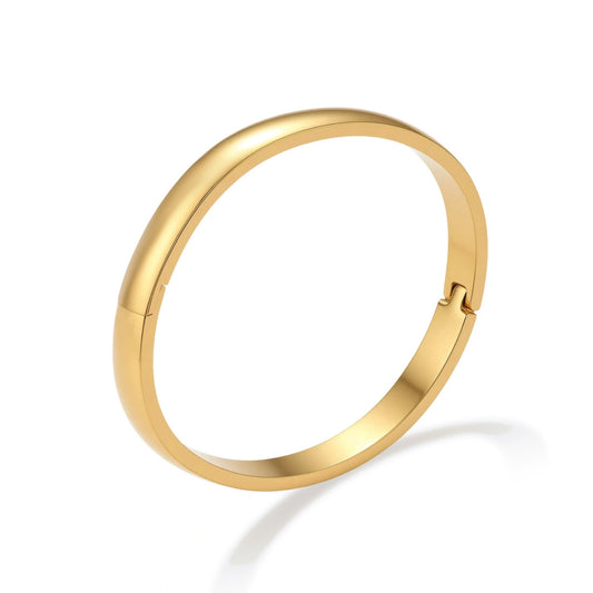 Polished 18K gold plated stainless steel hinge bangle with smooth flat-top profile on cream background.