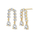 Gold-plated earrings with vertical line of clear crystals and teardrop pendants on neutral background