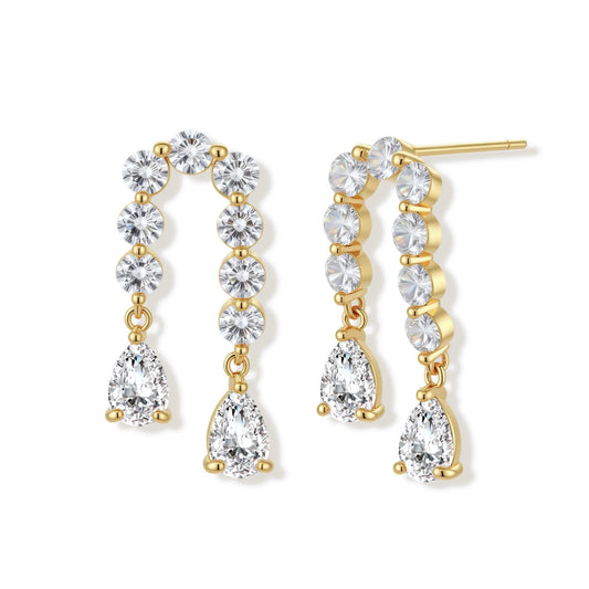Gold-plated earrings with vertical line of clear crystals and teardrop pendants on neutral background
