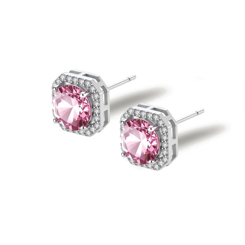 Pink moissanite studs in octagonal sterling silver halo settings with sparkling accent stones on cream background.
