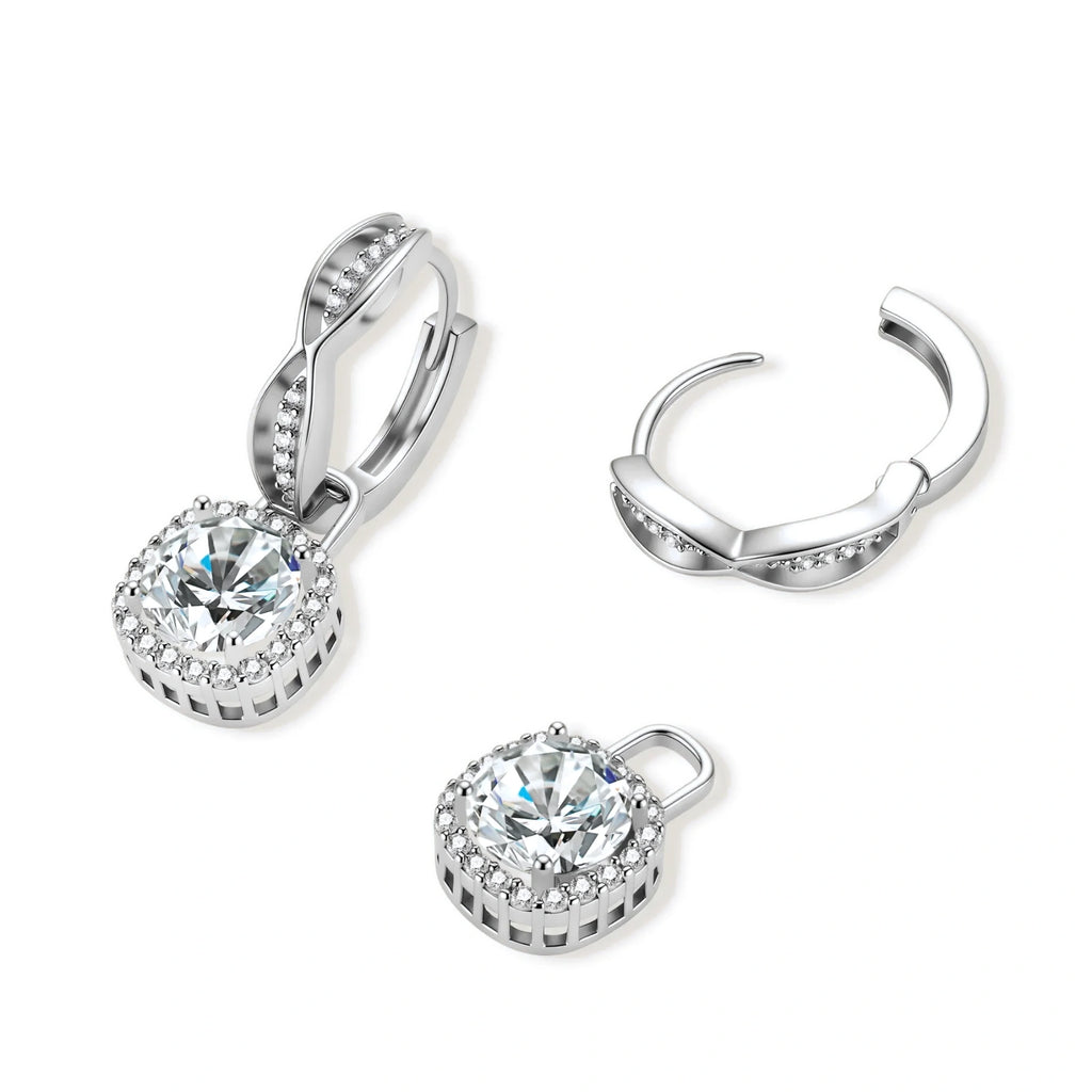 Sterling silver twisted hoop earrings with round moissanite stones in halo settings against neutral background.