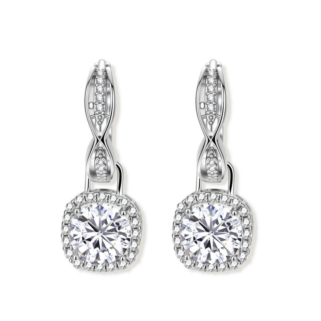 Sterling silver twisted hoop earrings with round moissanite stones in halo settings against neutral background.