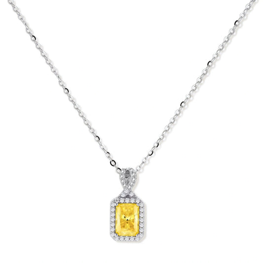 Yellow moissanite jewelry set with emerald-cut stones in sterling silver halo settings on white background.