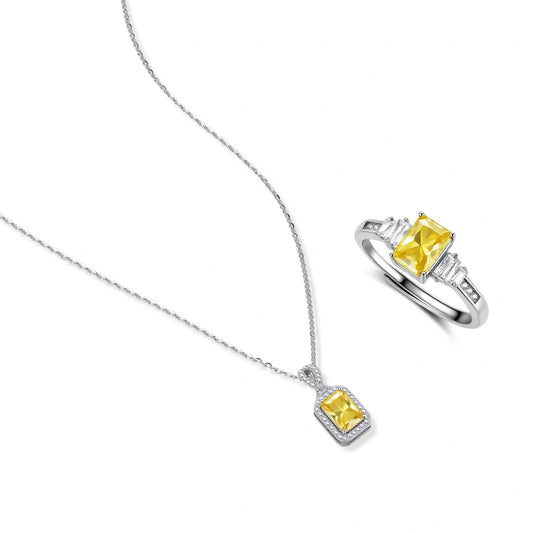Yellow moissanite jewelry set with emerald-cut stones in sterling silver halo settings on white background.