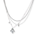 Multi-strand layered necklace set with silver chains, white pearls, star charm, heart pendant, and ornate decorative piece