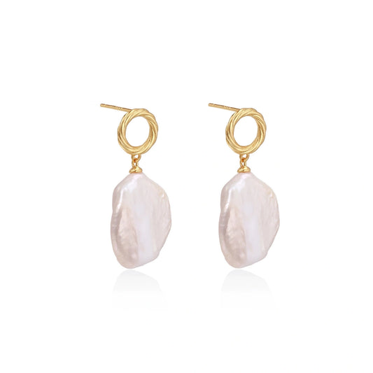 18K gold vermeil twisted circle studs with organic white baroque pearl drops on cream background