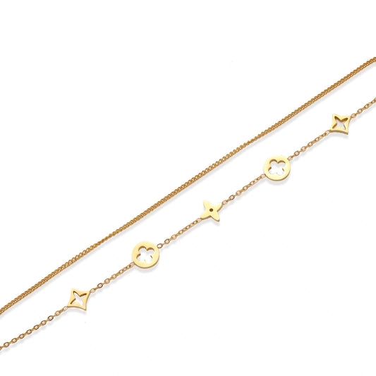 Double-layer gold-plated bracelet with quatrefoil and star charms on cream background, 18K gold finish.