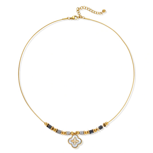 Gold-toned beaded necklace with grey stones and quatrefoil abalone shell pendant on cream background.