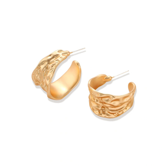 Close-up of textured hoop earrings with liquid metal ripple pattern in eco-zinc alloy with sterling silver posts.