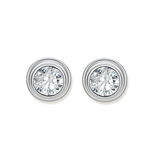 Close-up of sterling silver stud earrings featuring concentric circular frames with brilliant moissanite centers
