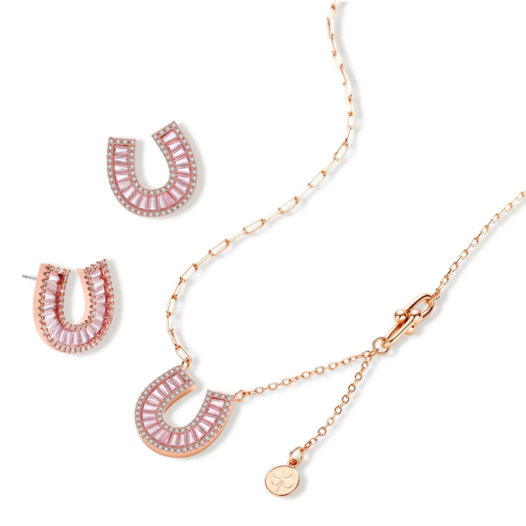 Sparkling horseshoe-shaped jewelry set with AAA cubic zirconia in gold-plated and white gold finishes on cream background.