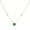 Delicate gold chain necklace featuring square emerald pendant with crystal halo and station accents