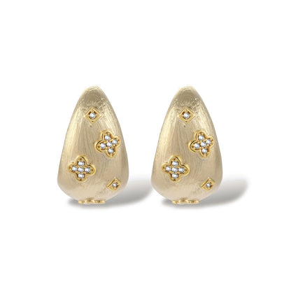 Curved gold-plated hoop earrings with four-leaf clover and diamond-shaped crystal details on white background