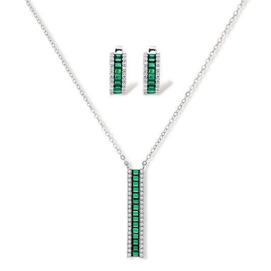 White gold plated jewelry set with emerald green rectangular stones and clear crystals in geometric rows on white background.
