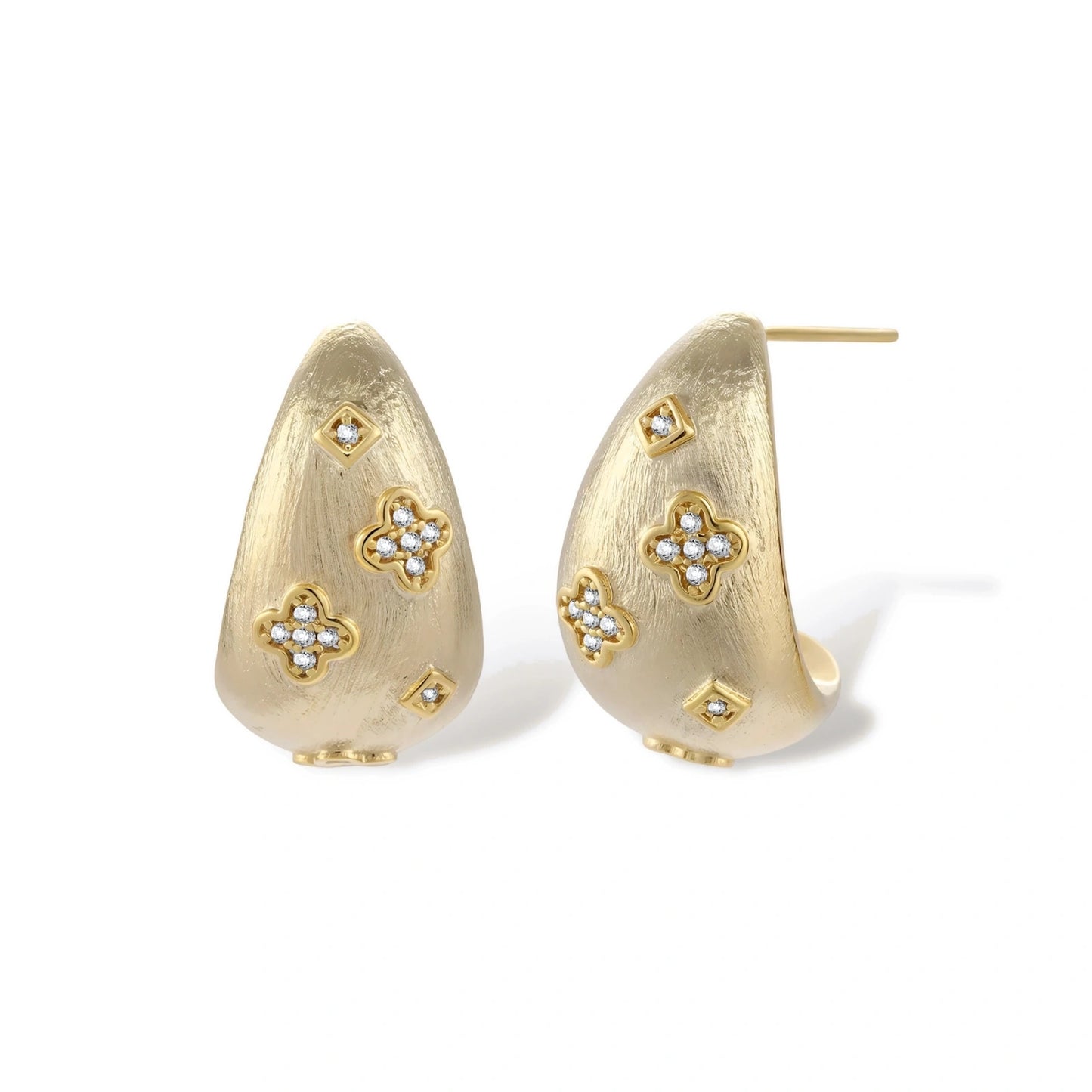 Curved gold-plated hoop earrings with four-leaf clover and diamond-shaped crystal details on white background