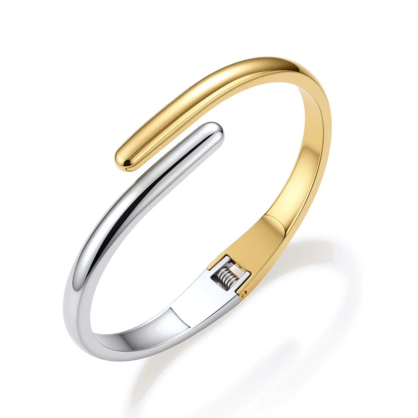 Polished two-tone bypass cuff bracelet in 18K gold plated and silver stainless steel with overlapping tapered ends.