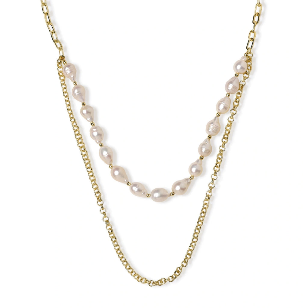 Layered gold chain necklace with organic baroque freshwater pearls and adjustable length on cream background