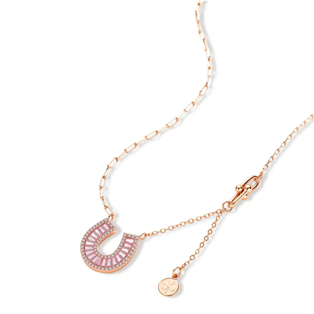Sparkling horseshoe-shaped jewelry set with AAA cubic zirconia in gold-plated and white gold finishes on cream background.
