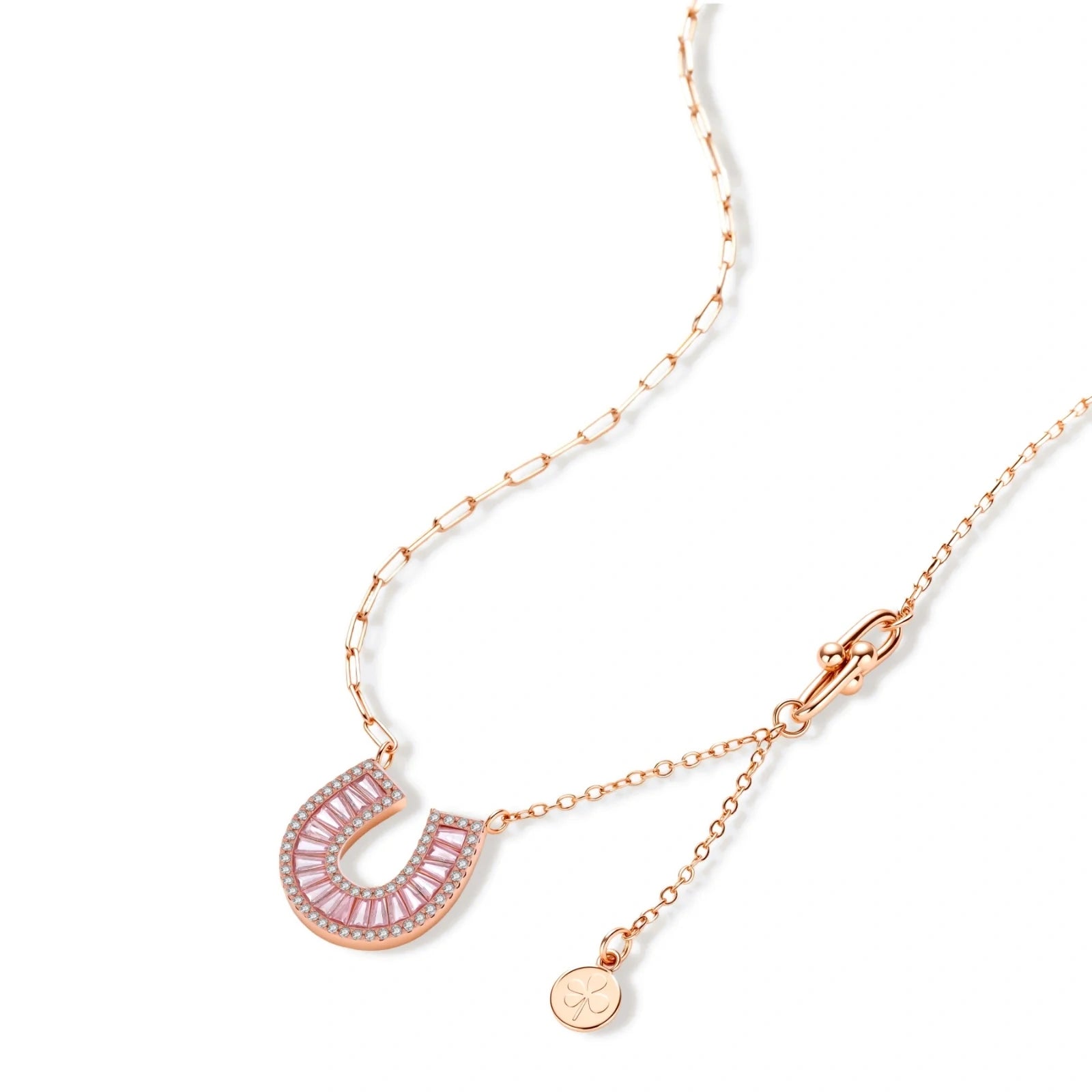 Sparkling horseshoe-shaped jewelry set with AAA cubic zirconia in gold-plated and white gold finishes on cream background.