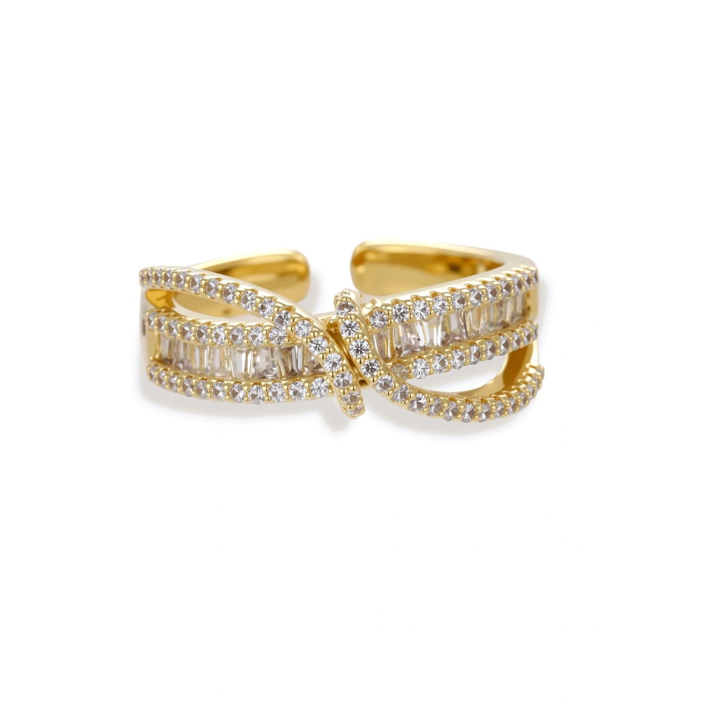 Close-up of gold-plated adjustable ring with crossing bands and sparkling zirconia stones on white background.