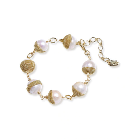Adjustable bracelet with baroque pearls wrapped in delicate gold mesh netting connected by textured chain links