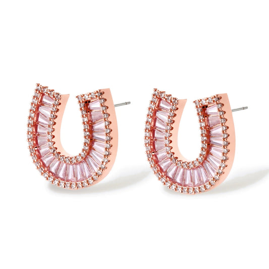 Sparkling horseshoe-shaped jewelry set with AAA cubic zirconia in gold-plated and white gold finishes on cream background.
