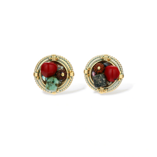 Circular gold-plated earrings with turquoise, coral, wood beads, and rope border detail on cream background.