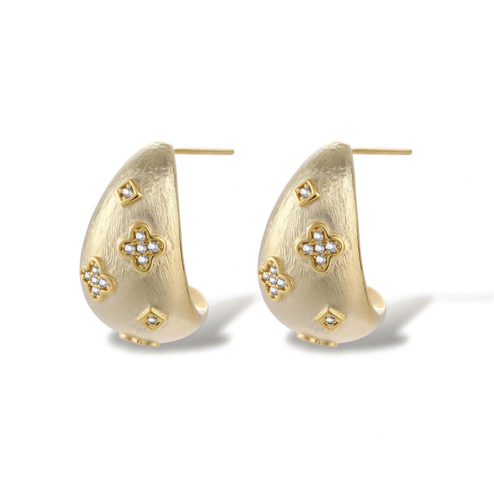 Curved gold-plated hoop earrings with four-leaf clover and diamond-shaped crystal details on white background